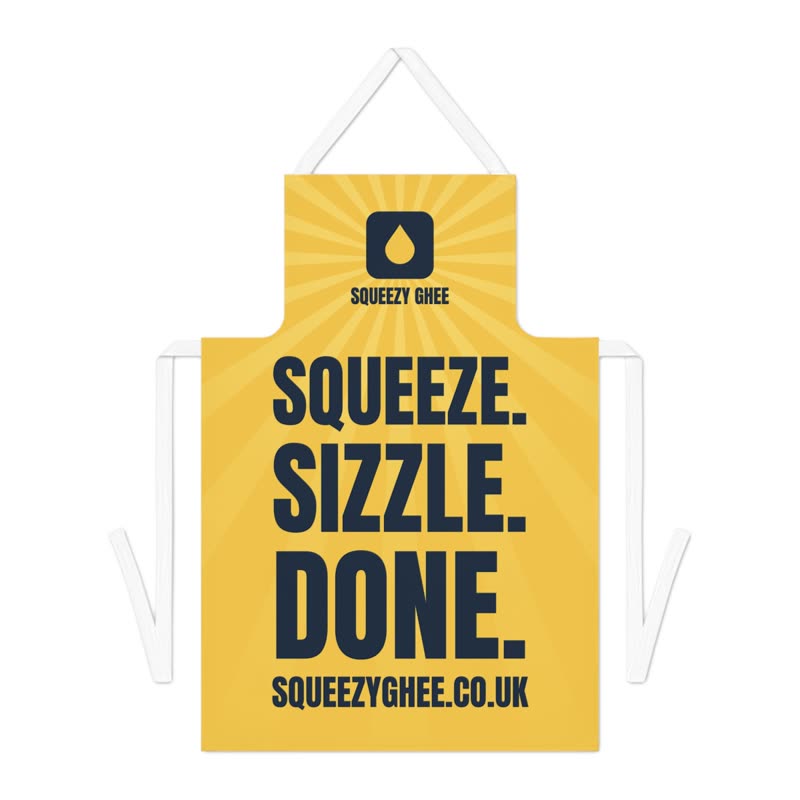 Butter-yellow apron: the mark on the bib and SQUEEZE. SIZZLE. DONE. across the skirt.